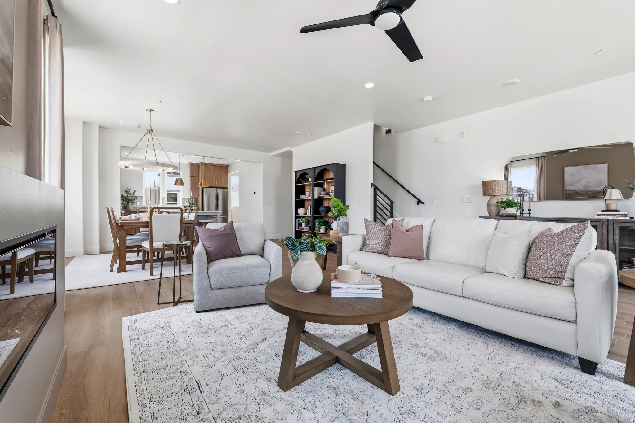 Open-concept living space featuring wood-finish flooring, recessed lighting, and a contemporary ceiling fan