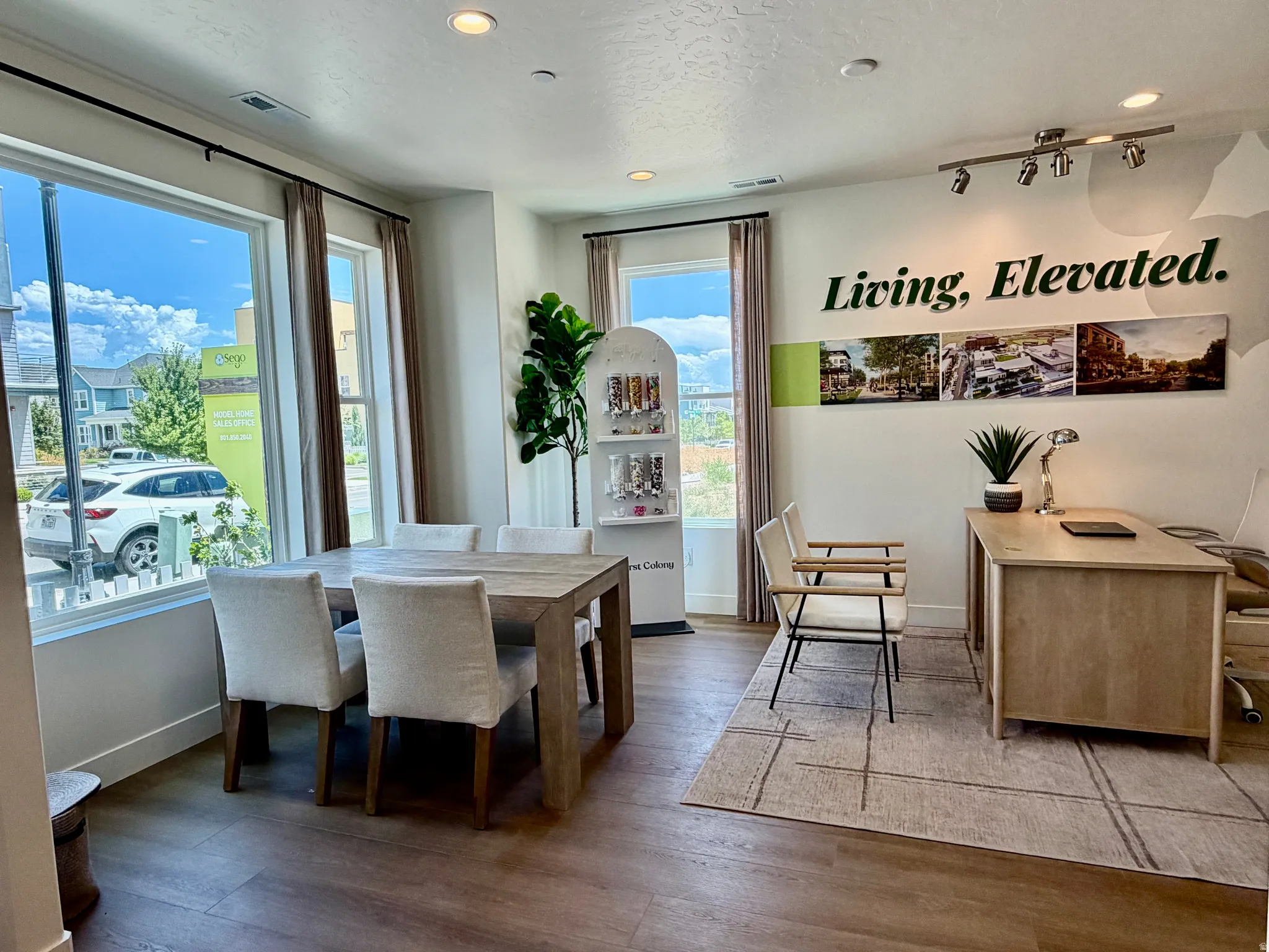 Spacious interior featuring wood-finish flooring, ample natural light from large windows, recessed lighting, and track lighting