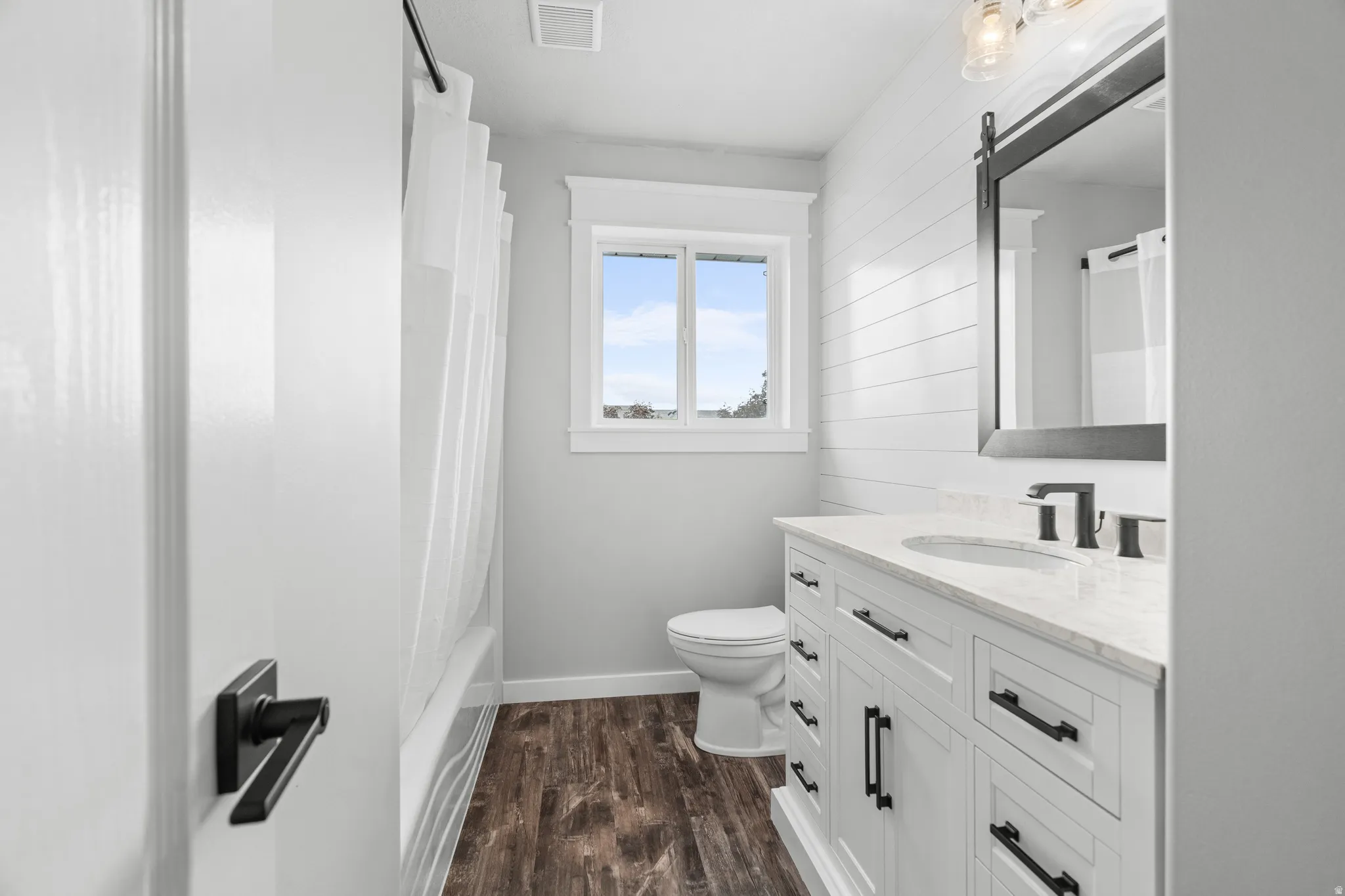 Upstairs bathroom featuring a white vanity with extensive storage, a white countertop, and a rectangular sink with a matte black faucet