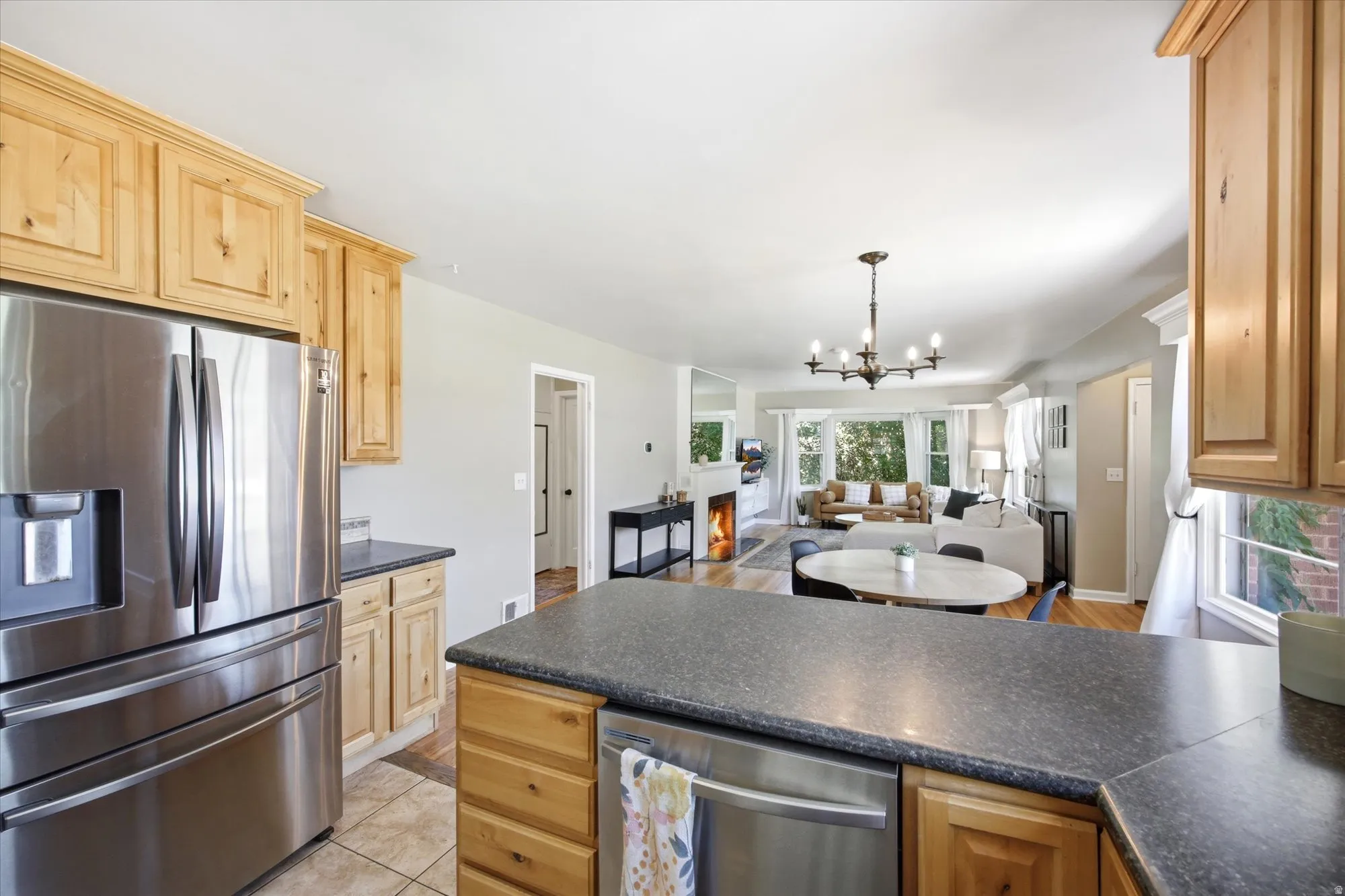 Kitchen featuring light wood cabinetry and dark countertops