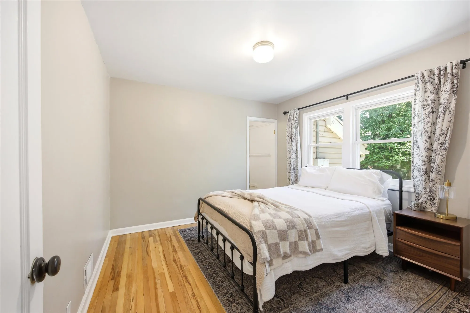Room featuring hardwood flooring and a neutral color palette