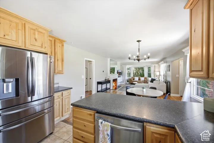 Kitchen featuring light wood cabinetry and dark countertops