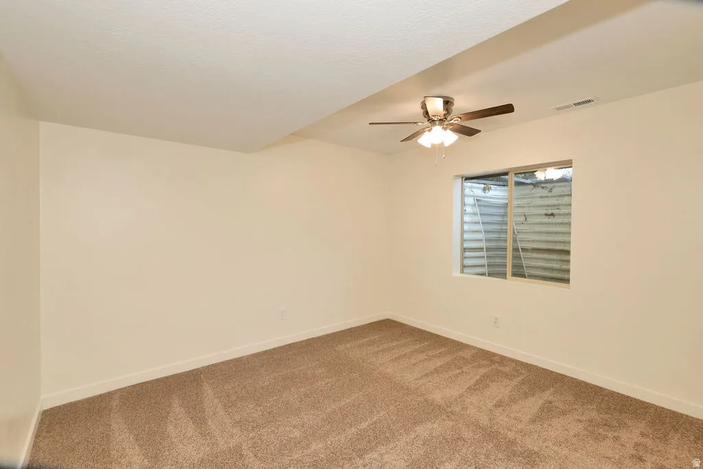 Room featuring neutral wall finishes and plush carpeting