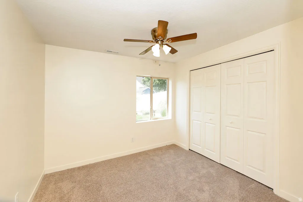 Neutral-toned walls and plush carpeting provide a versatile foundation