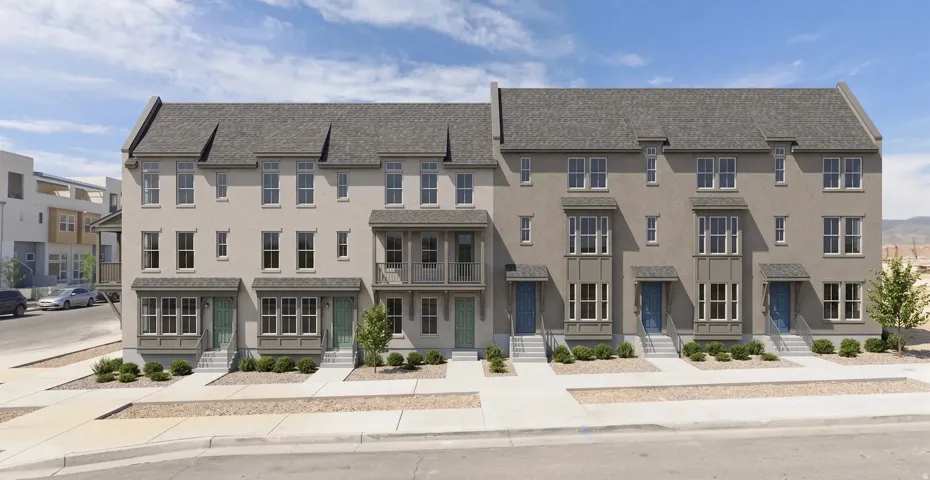 Row of multi-story townhomes featuring stucco exteriors and shingled gabled roofs