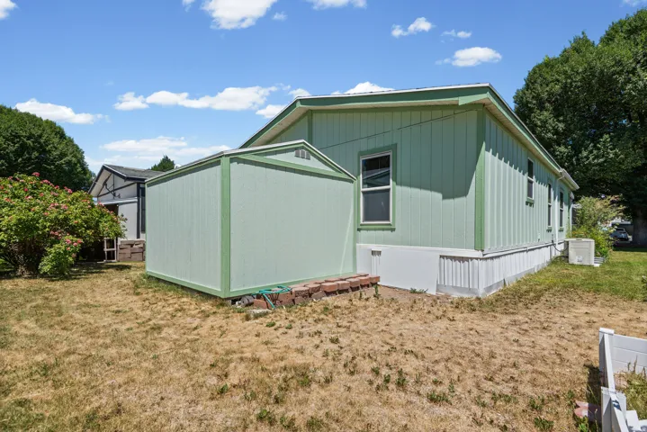 Green-sided storage shed with matching trim