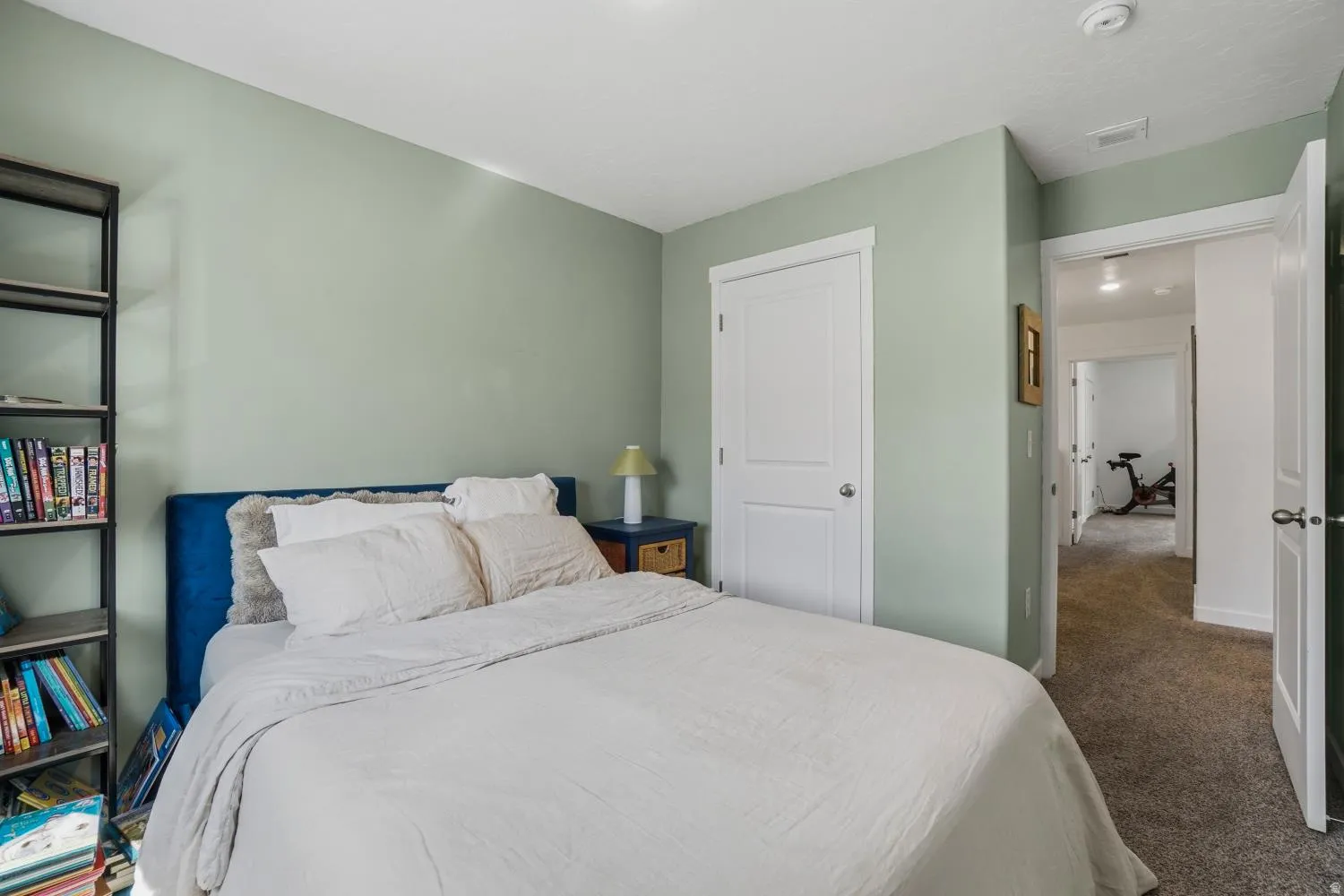 Bedroom featuring light green walls, white trim, and a white ceiling