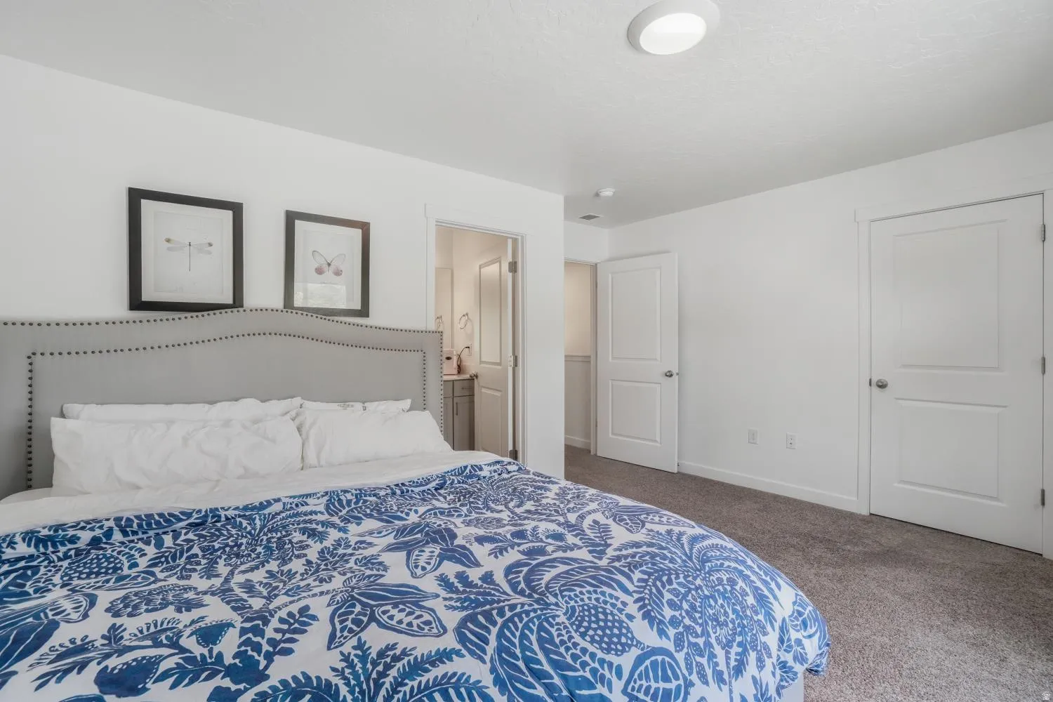 Bedroom featuring light gray carpet flooring and white painted walls