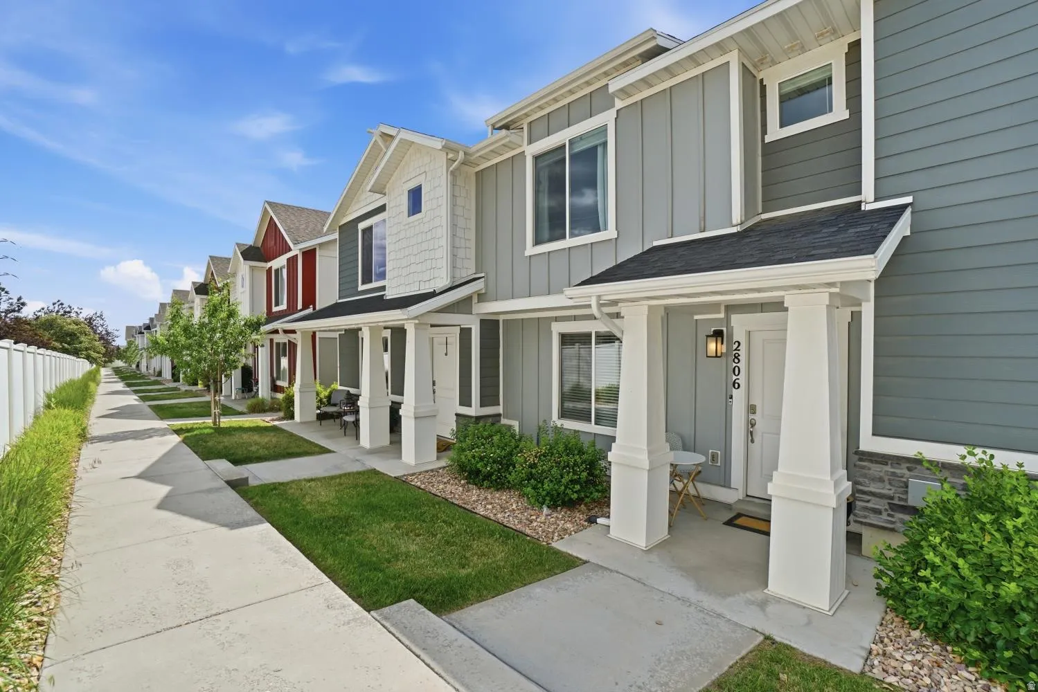 Contemporary row of townhomes featuring varied siding finishes including board and batten, horizontal, and shake