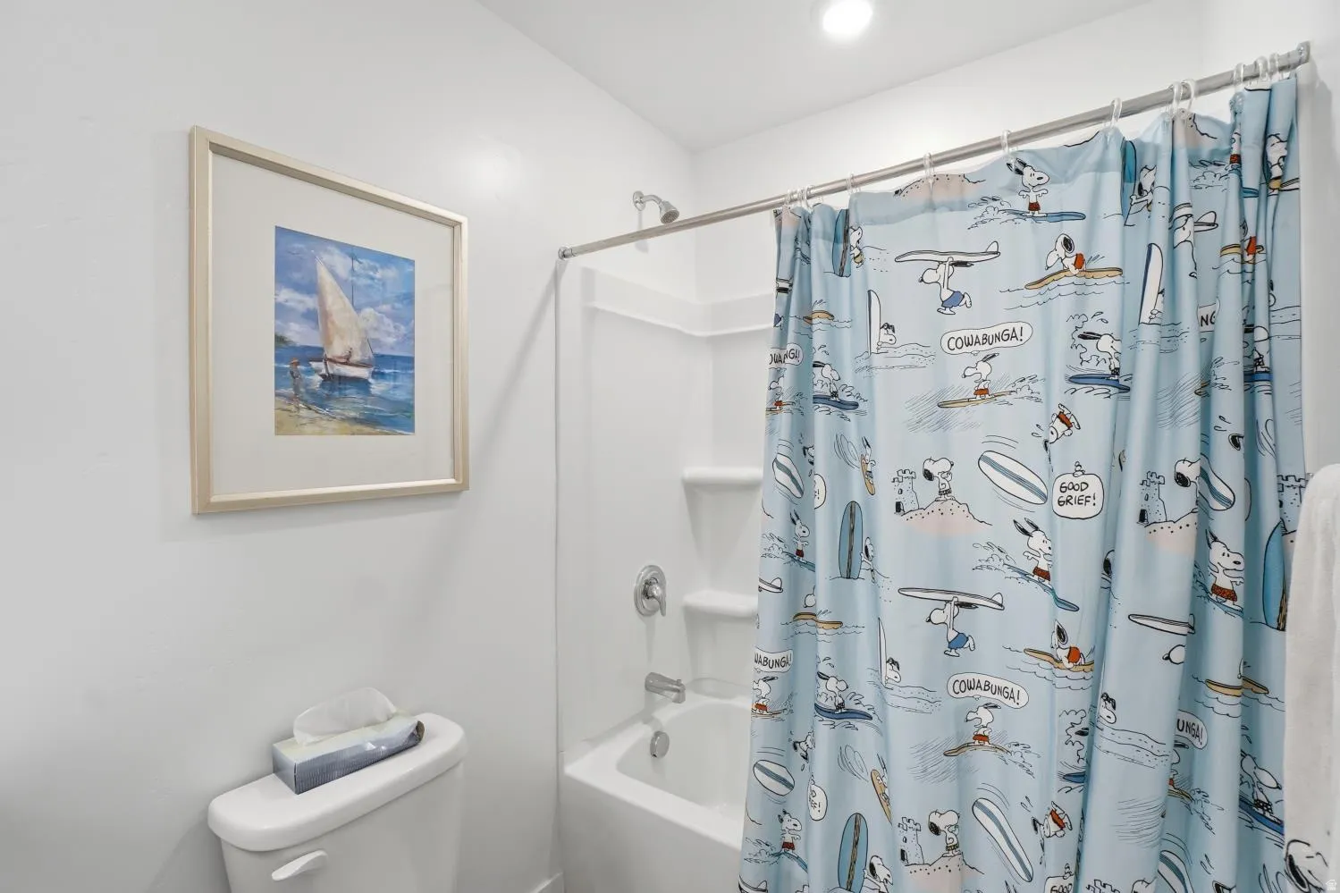 White tub and shower combination with a bright chrome shower fixture