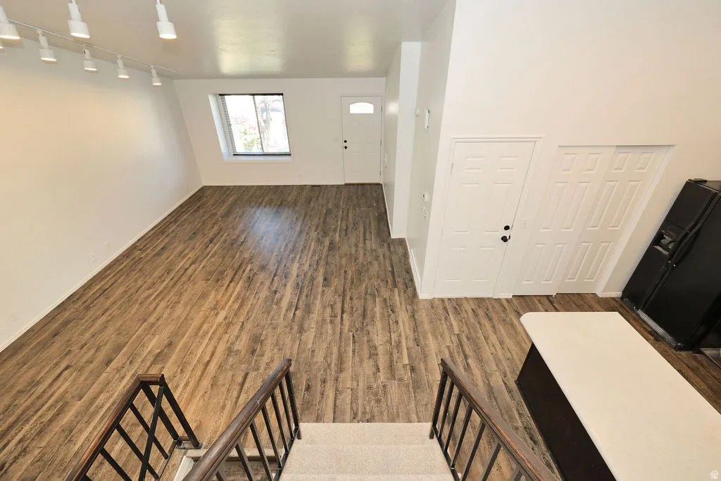 Open-concept living space with wood-finish flooring