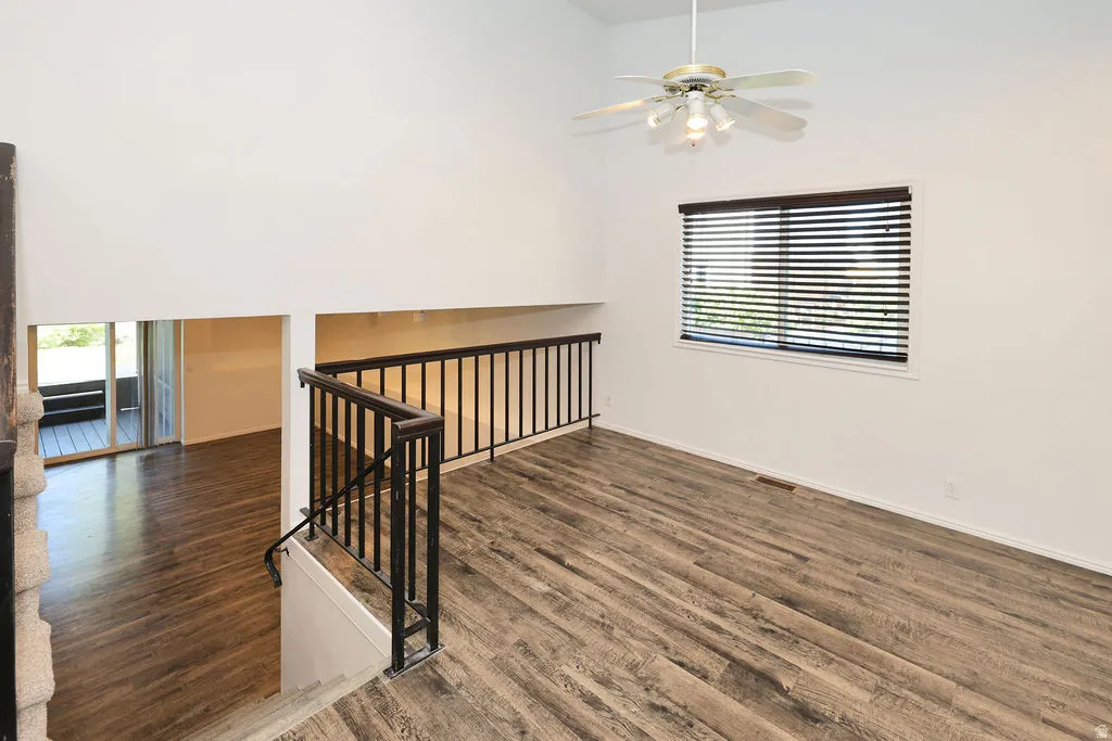 Open-concept upper level featuring high ceilings and wood-finish flooring