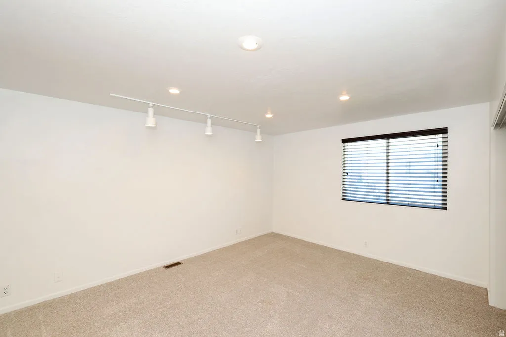 Neutral wall tones and plush carpeting create a versatile interior space