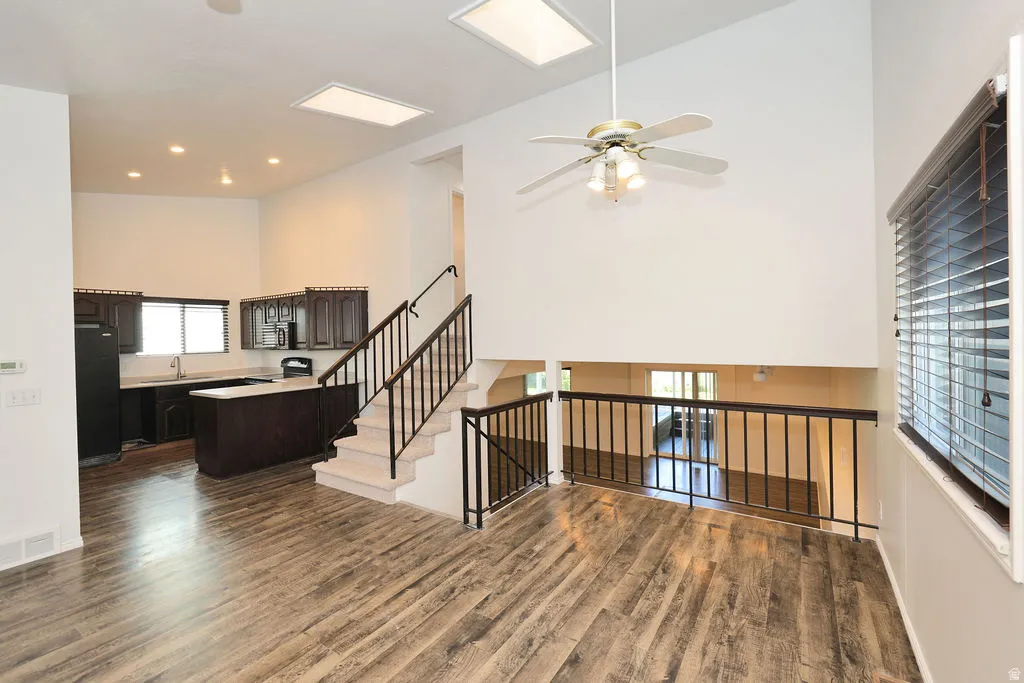 Vaulted ceilings featuring a ceiling fan with integrated lighting