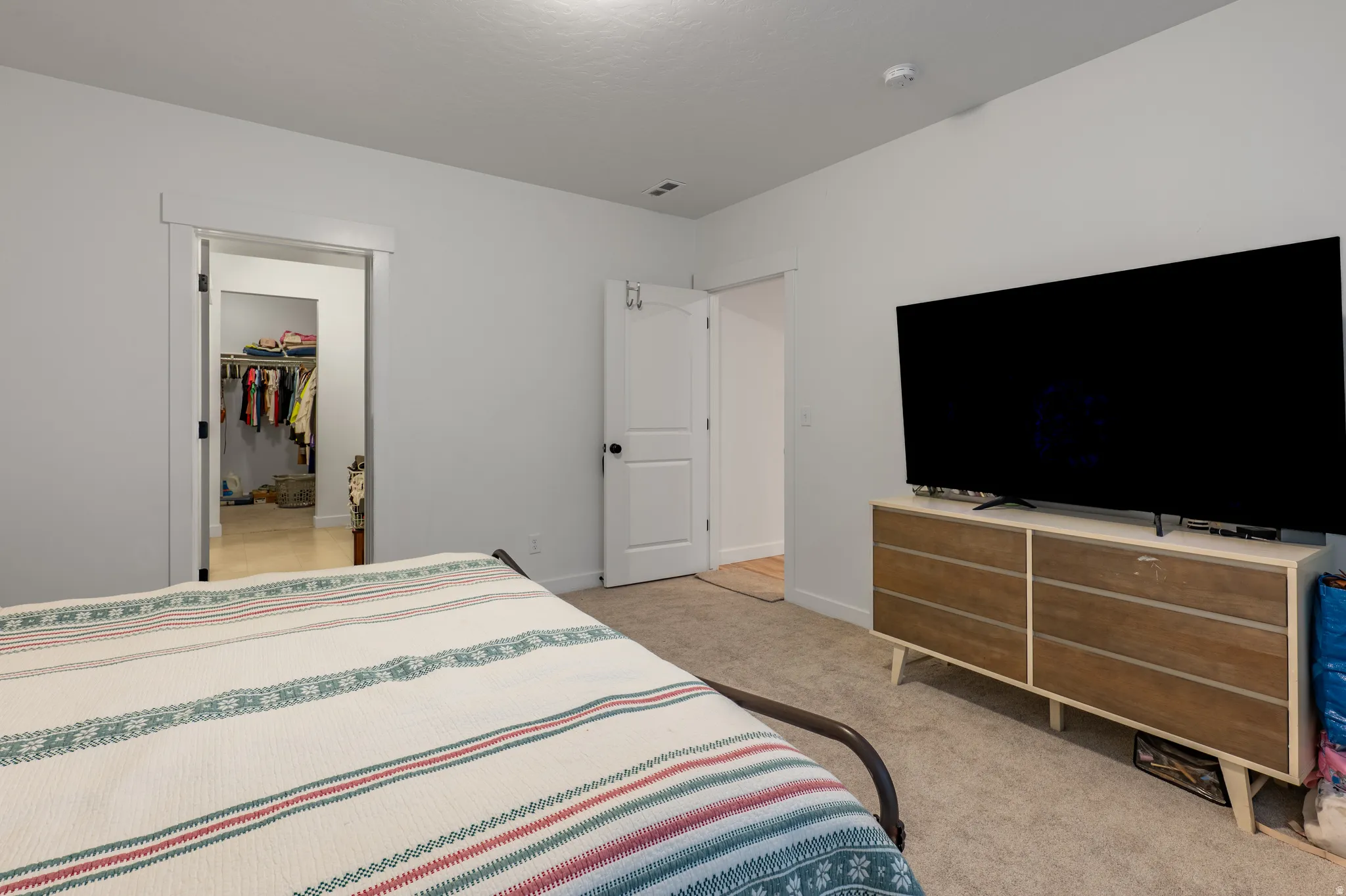 Carpeted room with light gray walls and white trim