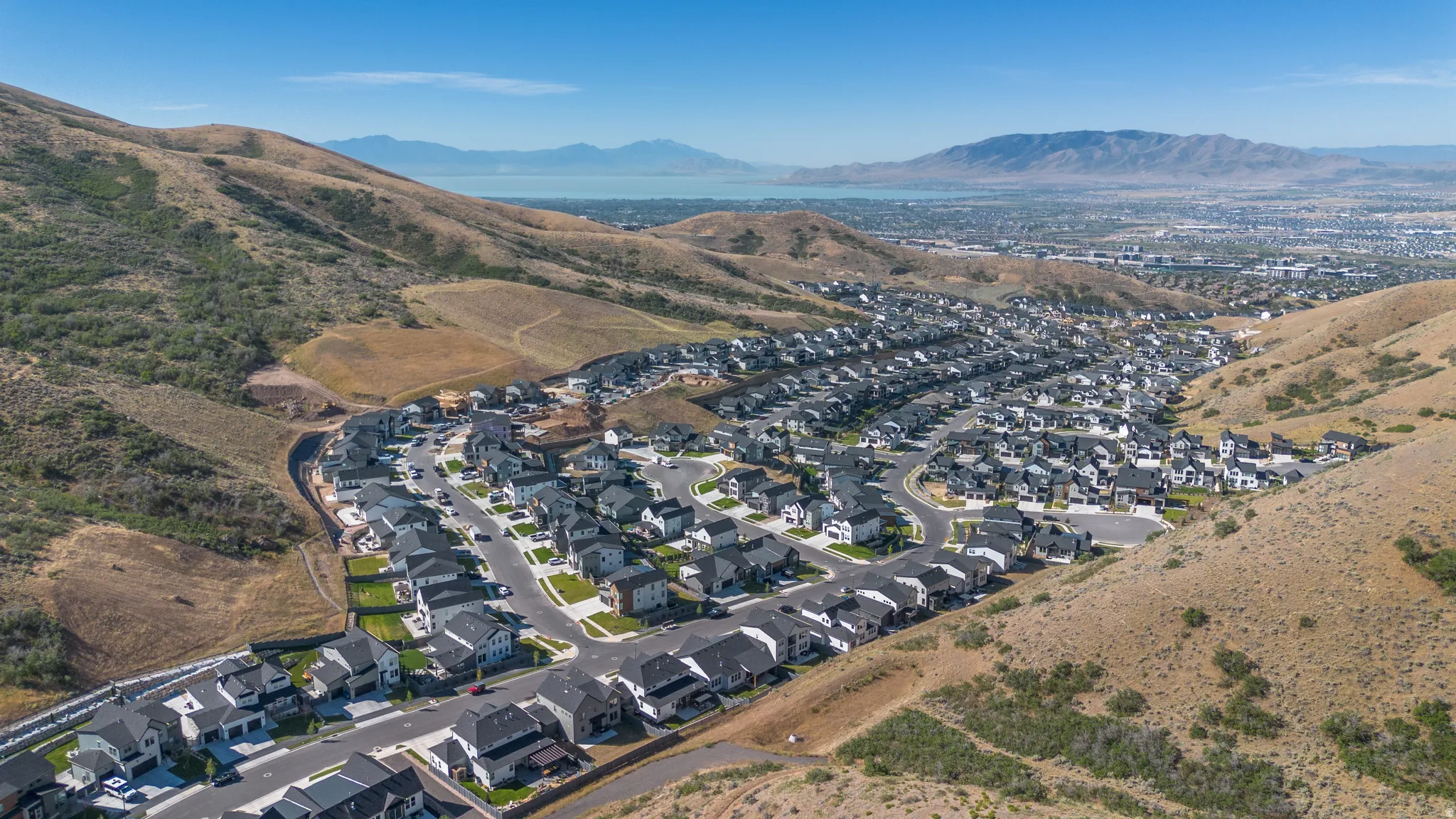 Aerial perspective of a developed residential community featuring numerous single-family homes