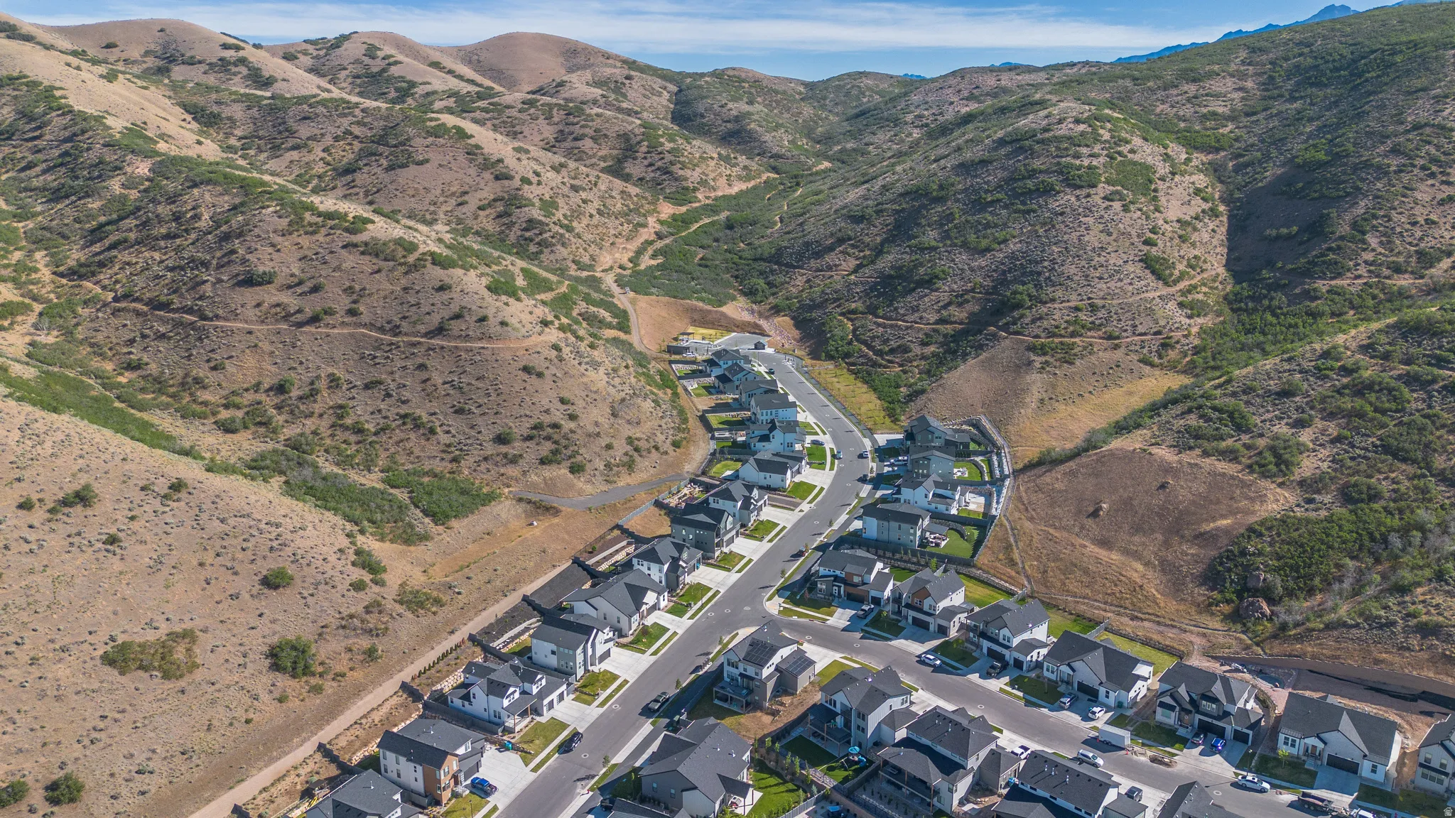 Residential development nestled within rolling hills