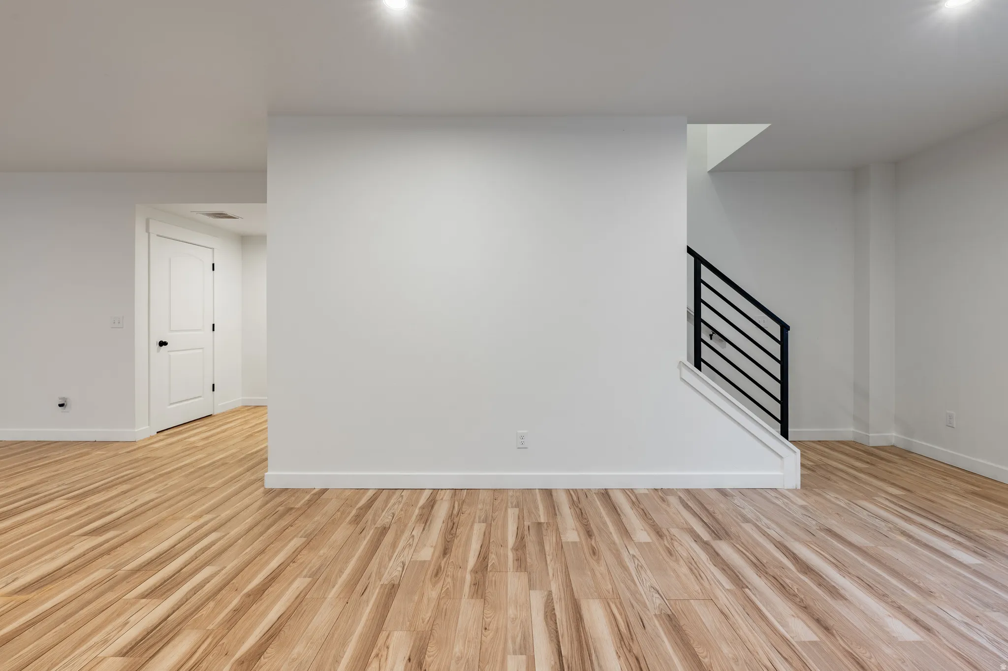 Open concept interior featuring wide plank wood-finish flooring