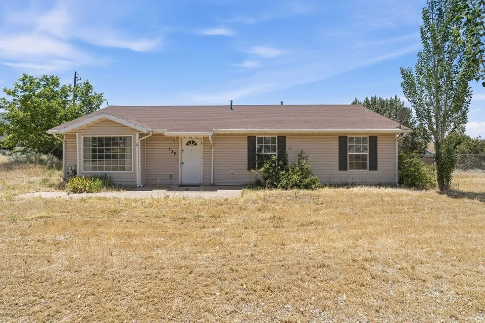 Ranch-style exterior with horizontal siding, a gabled roof, and a bay window