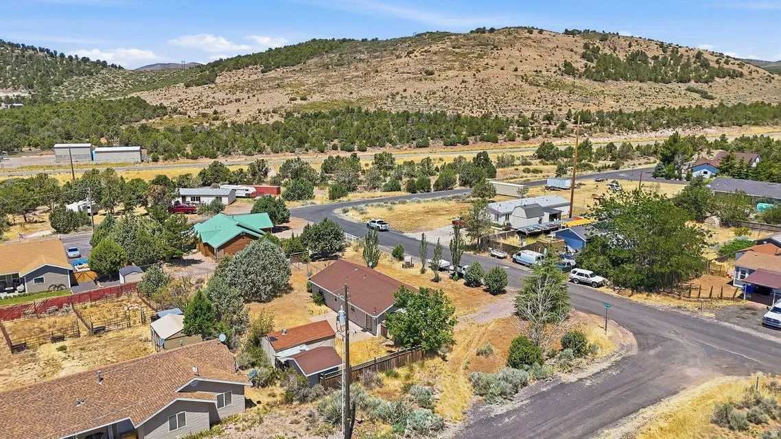 Residential neighborhood featuring a paved street and surrounding natural landscape