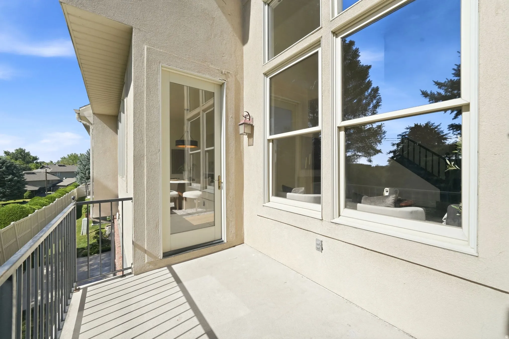 Exterior balcony with concrete flooring and dark metal railings