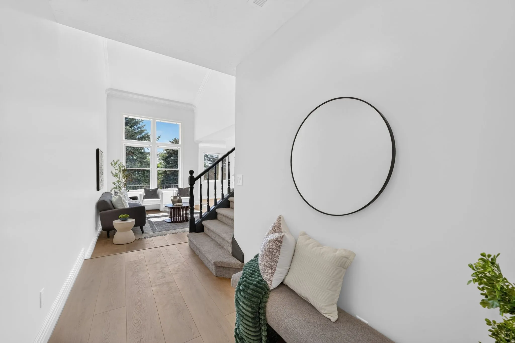 Light wood-finish flooring extending into a bright living space