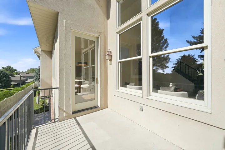 Exterior balcony with concrete flooring and dark metal railings