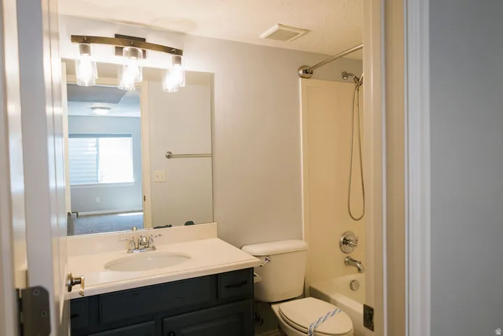 Bathroom featuring a dark wood-finish vanity with a white countertop and integrated sink