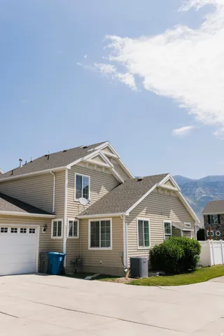 Neutral-toned siding exterior with white window frames and trim