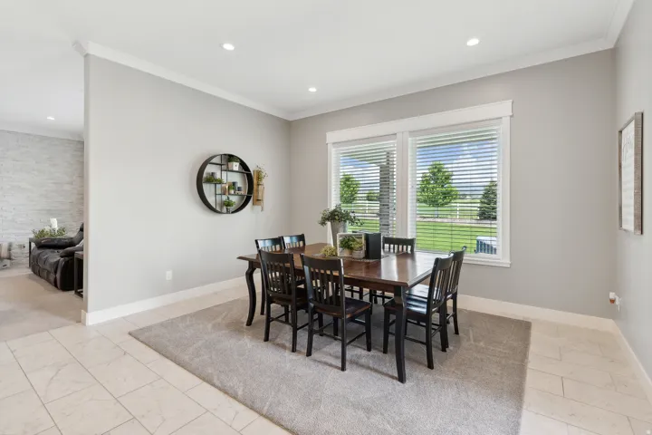 Dining area featuring recessed lighting, crown molding, and two large windows with horizontal blinds