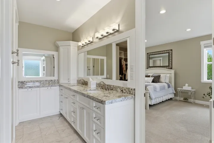 Dual vanity bathroom featuring stone countertops, recessed lighting, white cabinetry, and tile flooring
