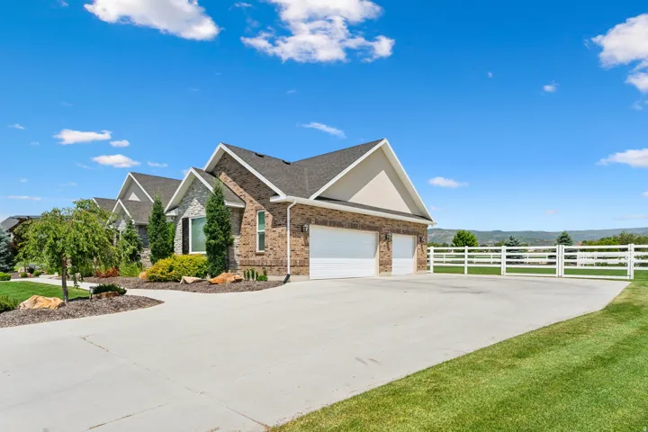 Brick and stone exterior with a two-car garage