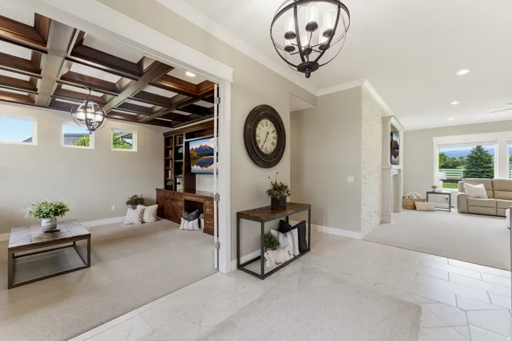 Coffered wood ceiling with a built-in media center, recessed lighting, and carpeted flooring
