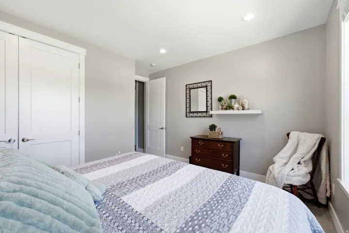 Bedroom featuring two panel interior doors, recessed lighting, neutral wall tones, and a window with natural light