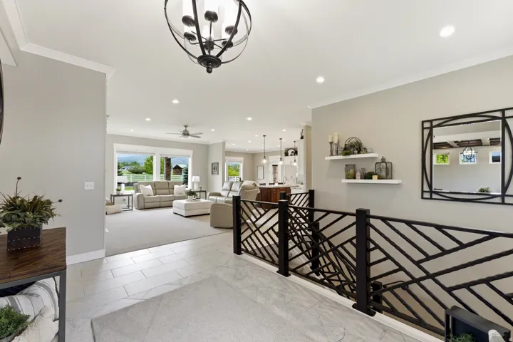 Entryway featuring tile flooring, a decorative iron railing, recessed lighting, and a modern chandelier