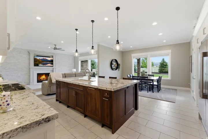 Central kitchen island featuring dark wood cabinetry and a light-toned countertop