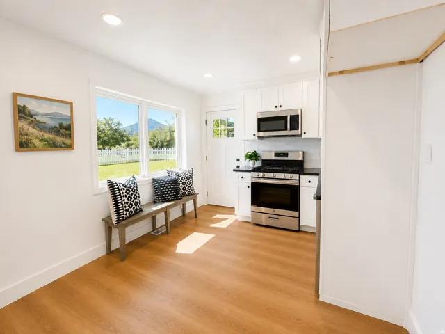 Kitchen and dining area featuring wood-finish flooring, recessed lighting, and a window with mountain and garden views