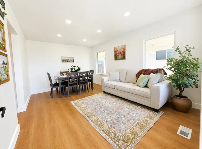 Open-concept living area featuring wood-finish flooring and recessed ceiling lights