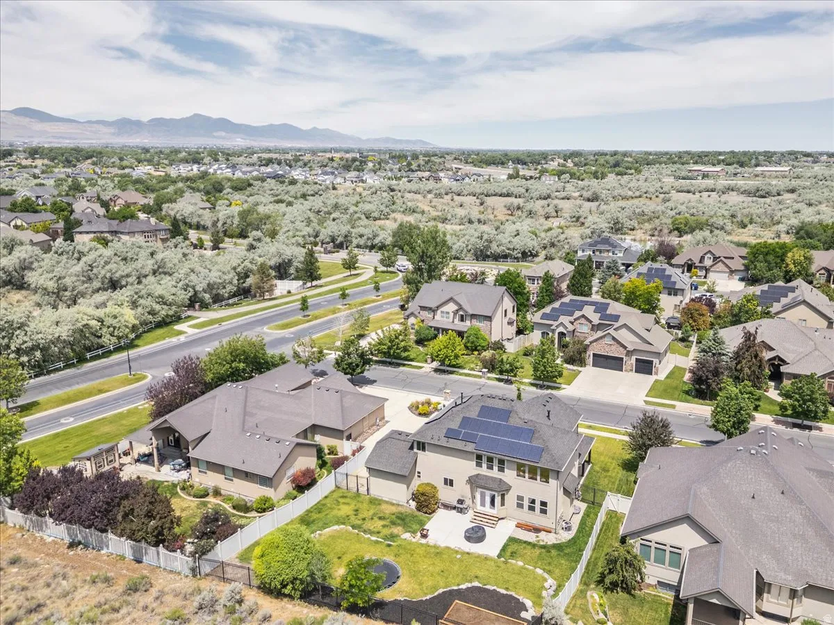 Aerial perspective of a neighborhood featuring residential structures and distant mountains