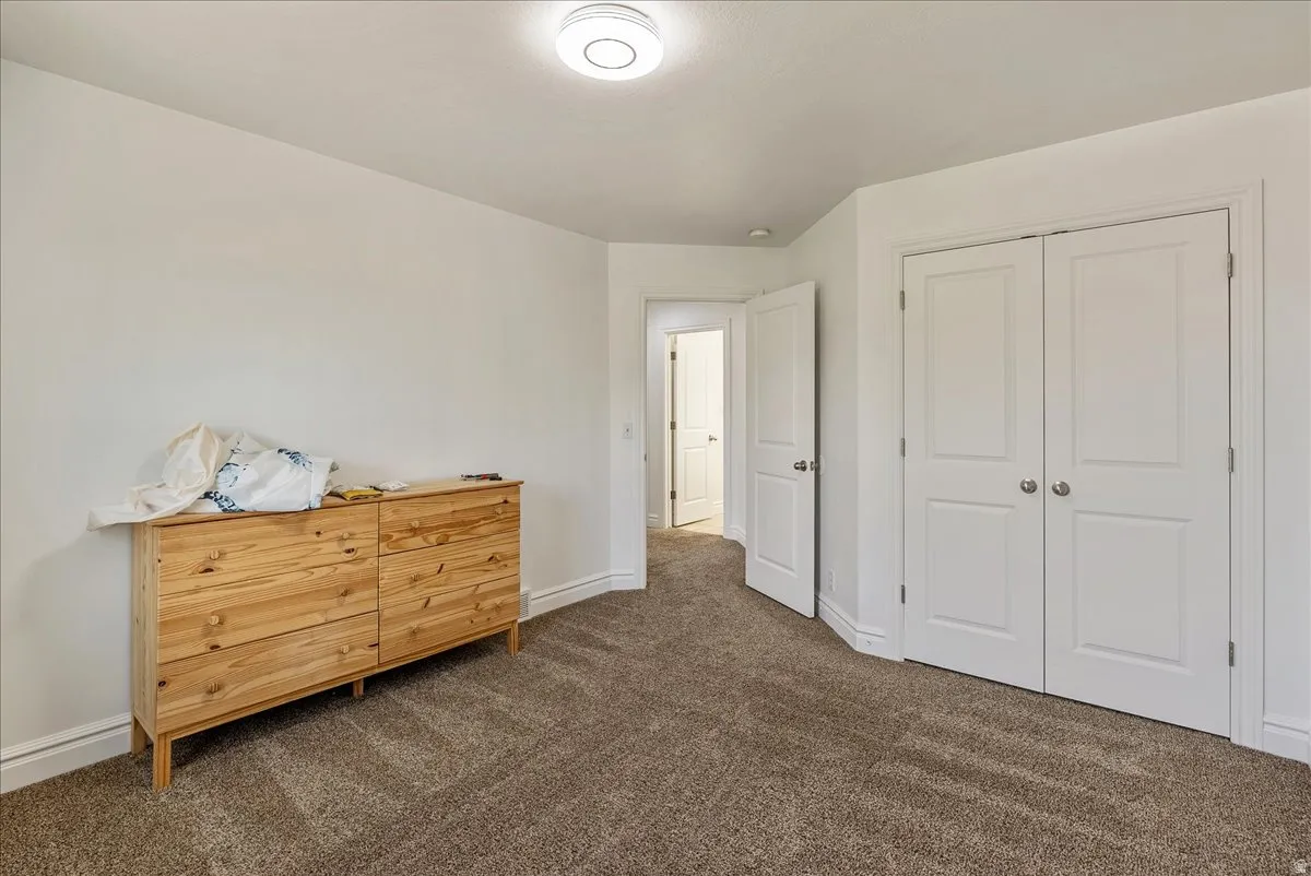Neutral wall paint with textured carpet flooring