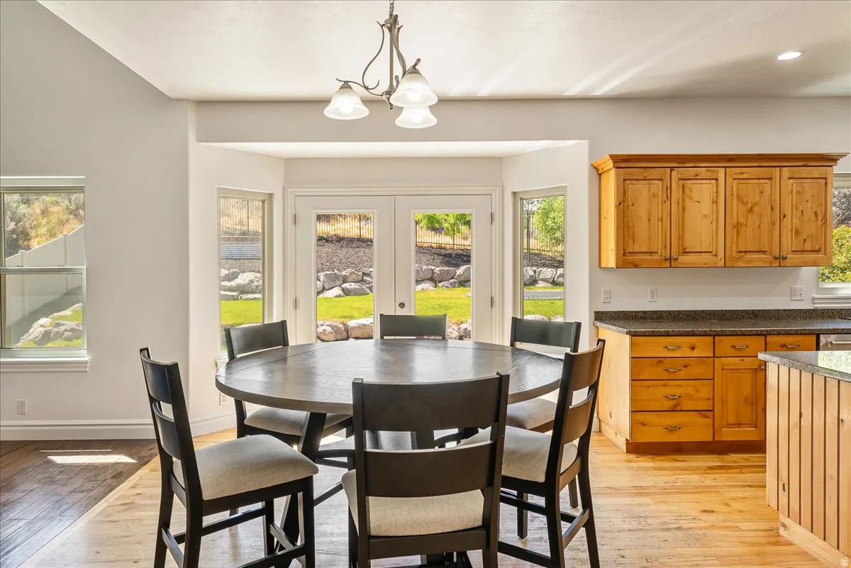 Dining area featuring wood-finish flooring and a bay window with double doors