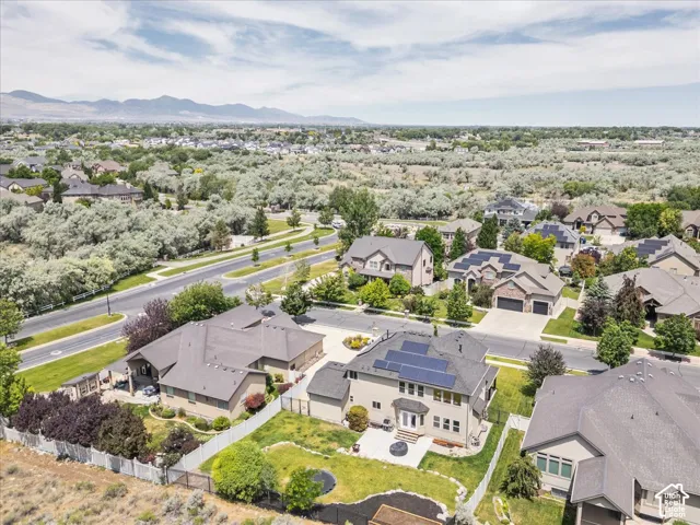 Aerial perspective of a neighborhood featuring residential structures and distant mountains