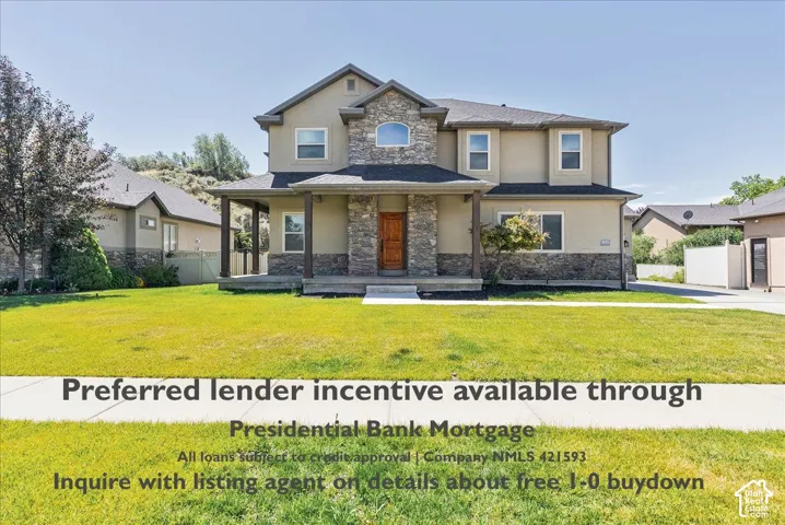 Stucco and stone exterior with covered front porch, asphalt shingle roof, and attached driveway