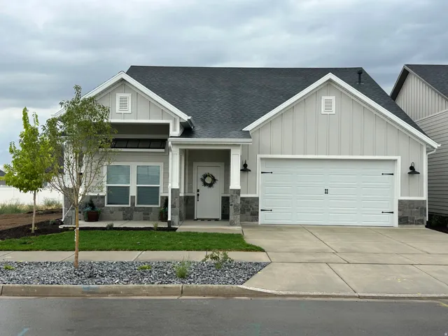 Light-toned siding with dark shingle roofing