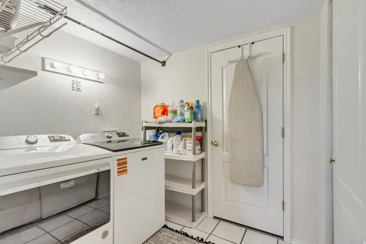 Dedicated utility area featuring white appliances