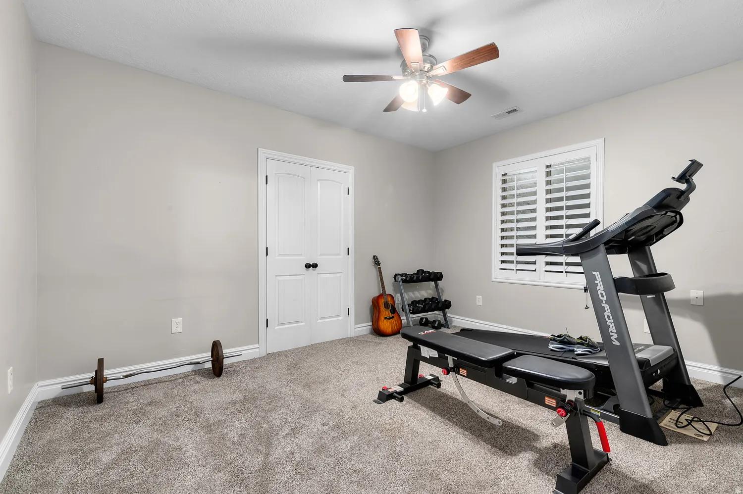 Room featuring light gray wall paint and gray carpeting