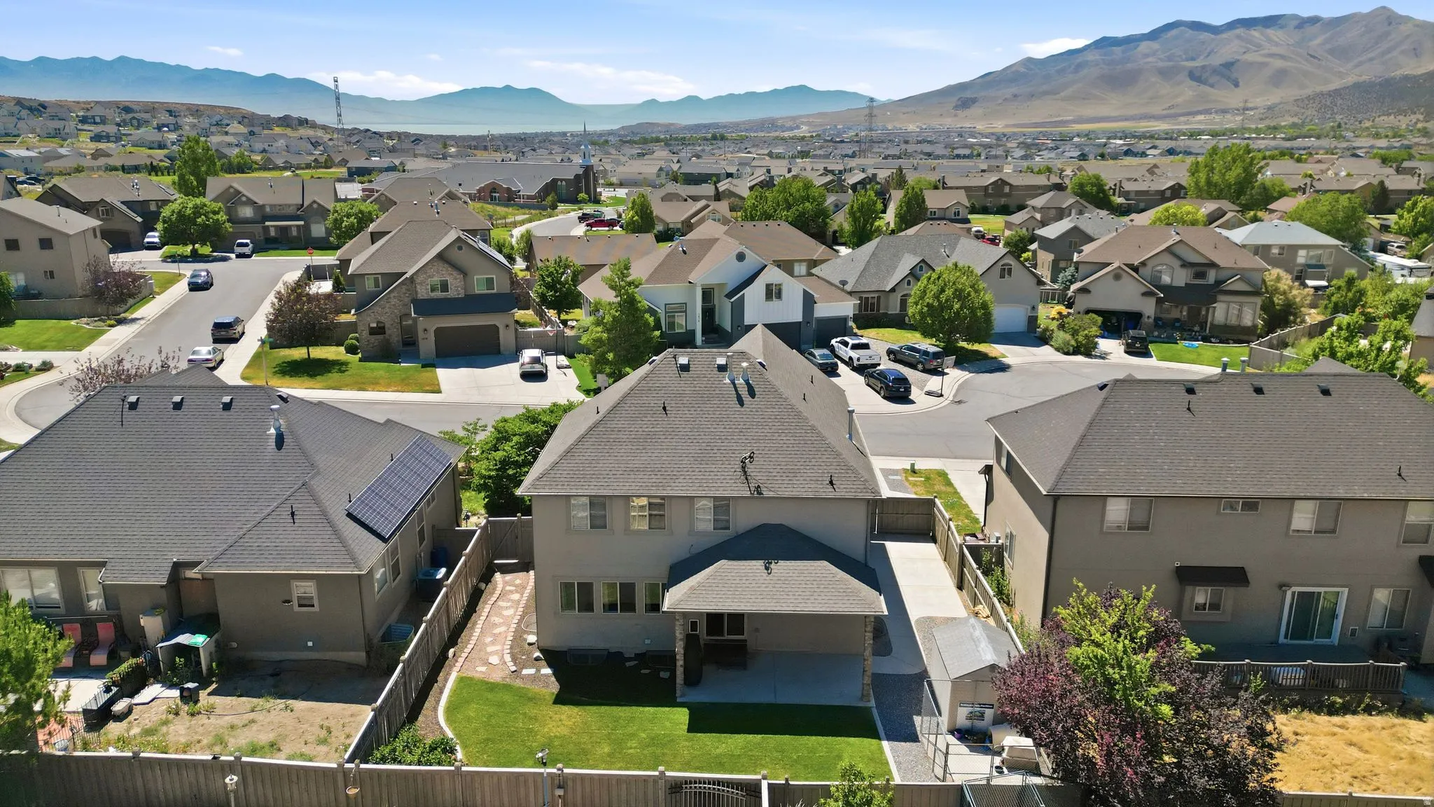 Residential neighborhood featuring single-family homes with pitched roofs and varied exterior finishes