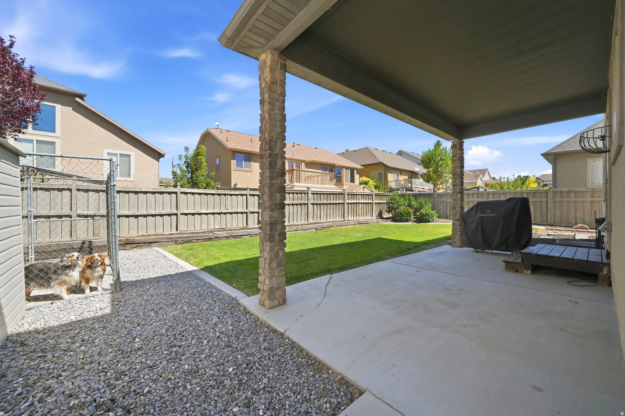 Covered patio featuring concrete flooring and stone-clad columns