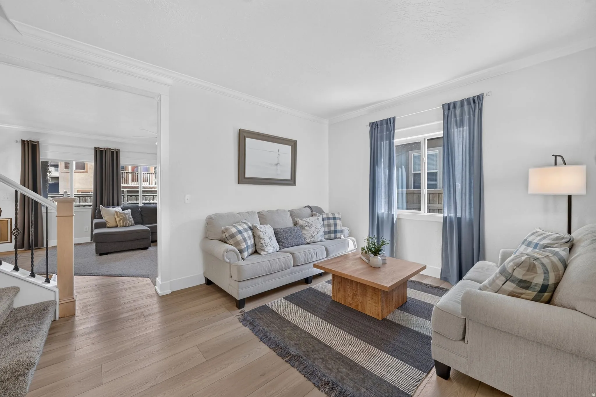 Bright living area featuring wood-finish flooring and white walls