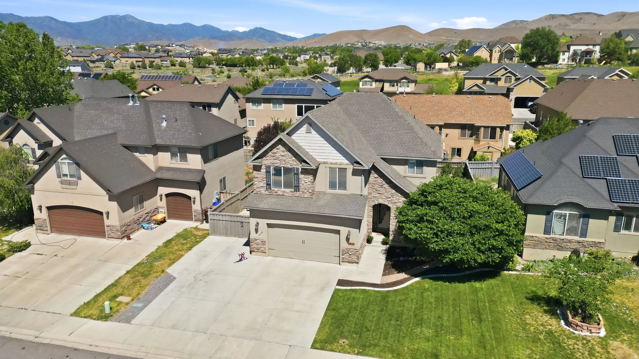 Stucco and stone exterior with a two-car garage